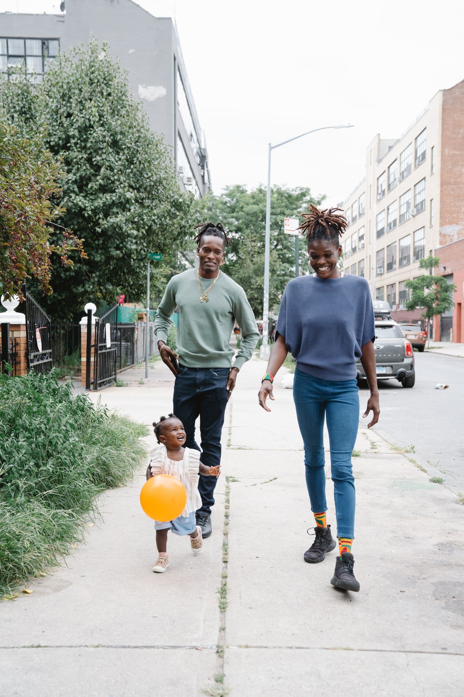 A family smiling and walking together